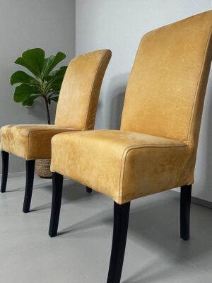 High-back leather dining chairs by Coricraft