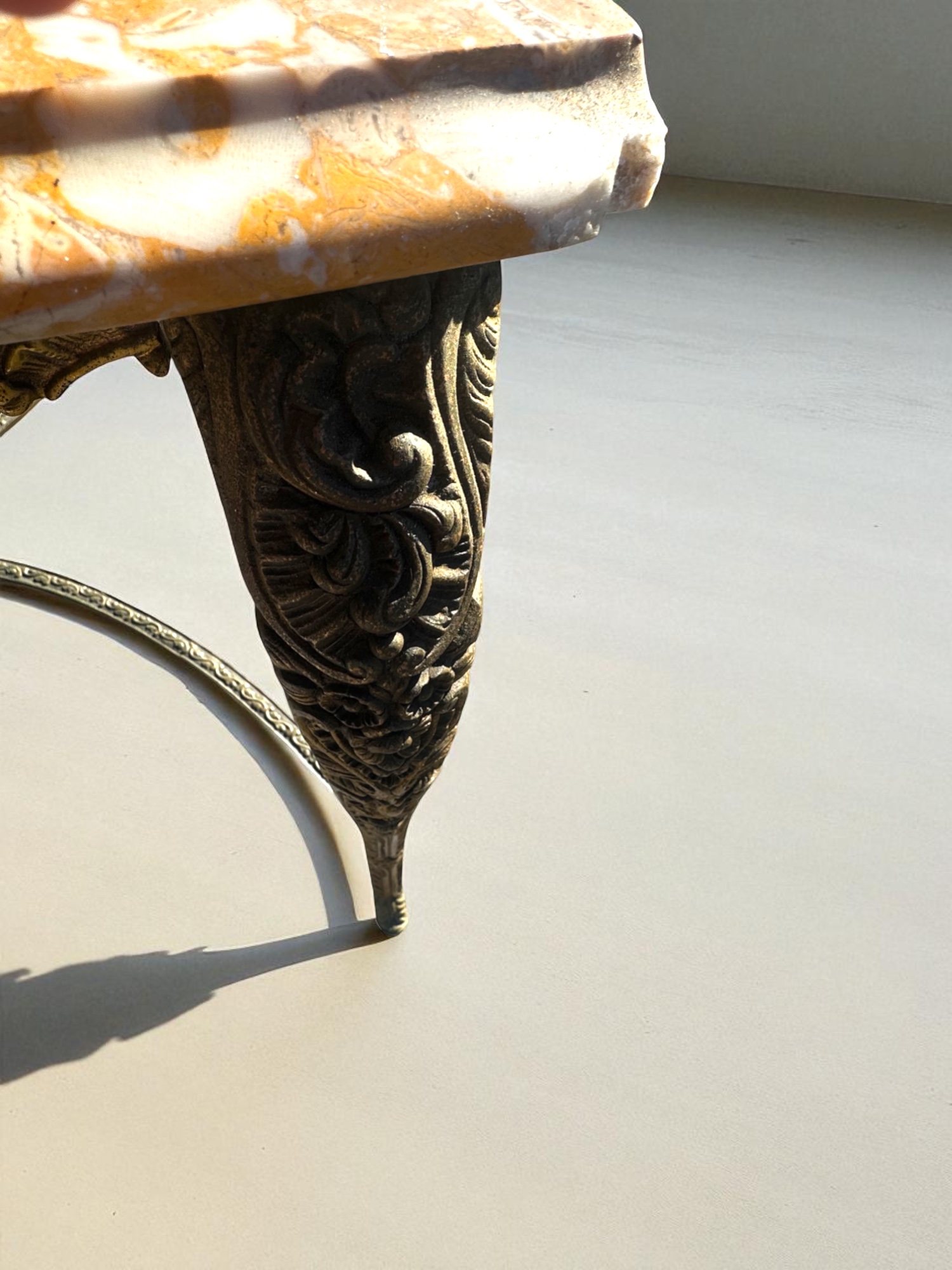 Close-up of ornate brass carvings on table legs